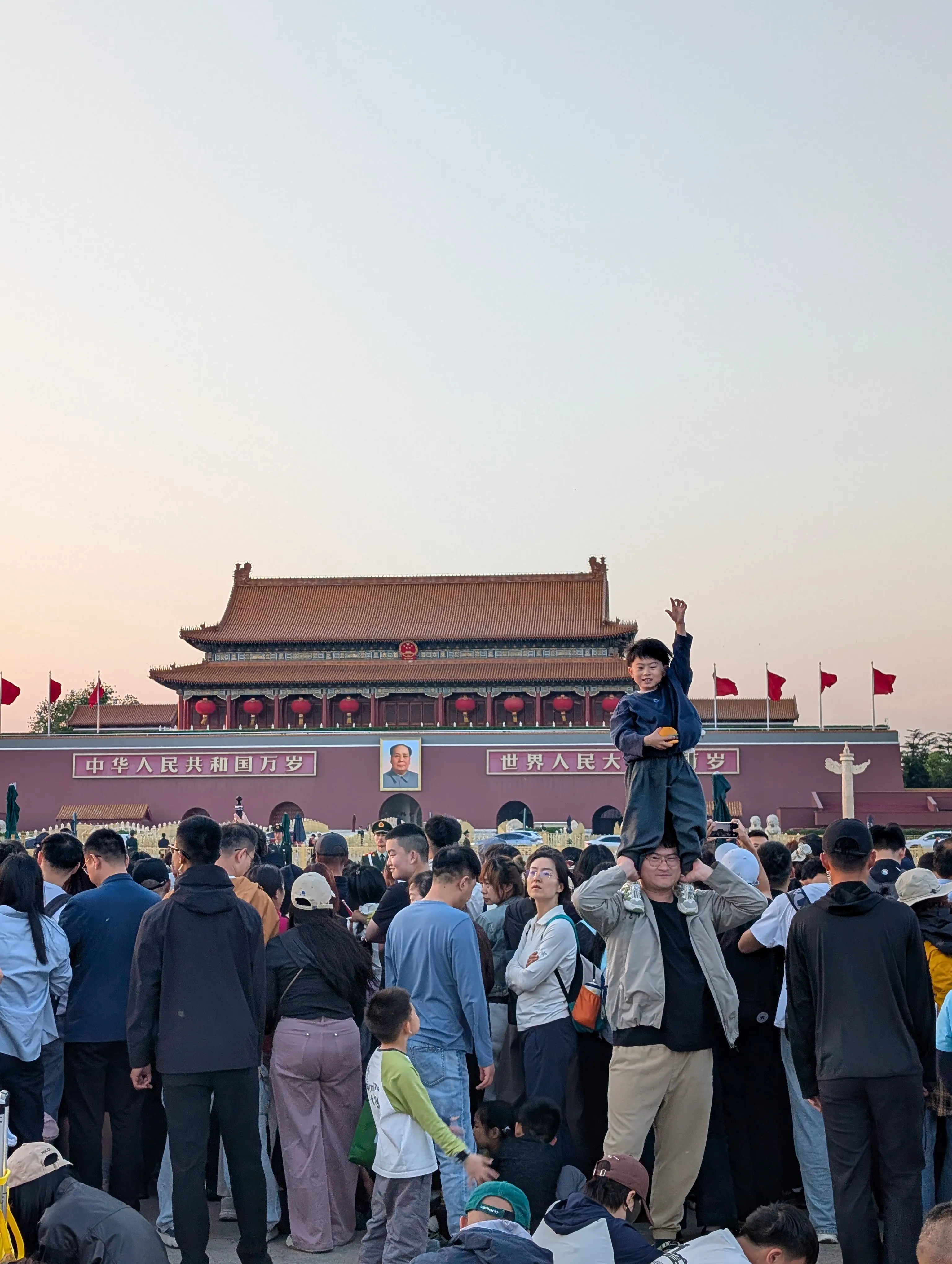Boy in front of Mao portrait in Tiananmen Square