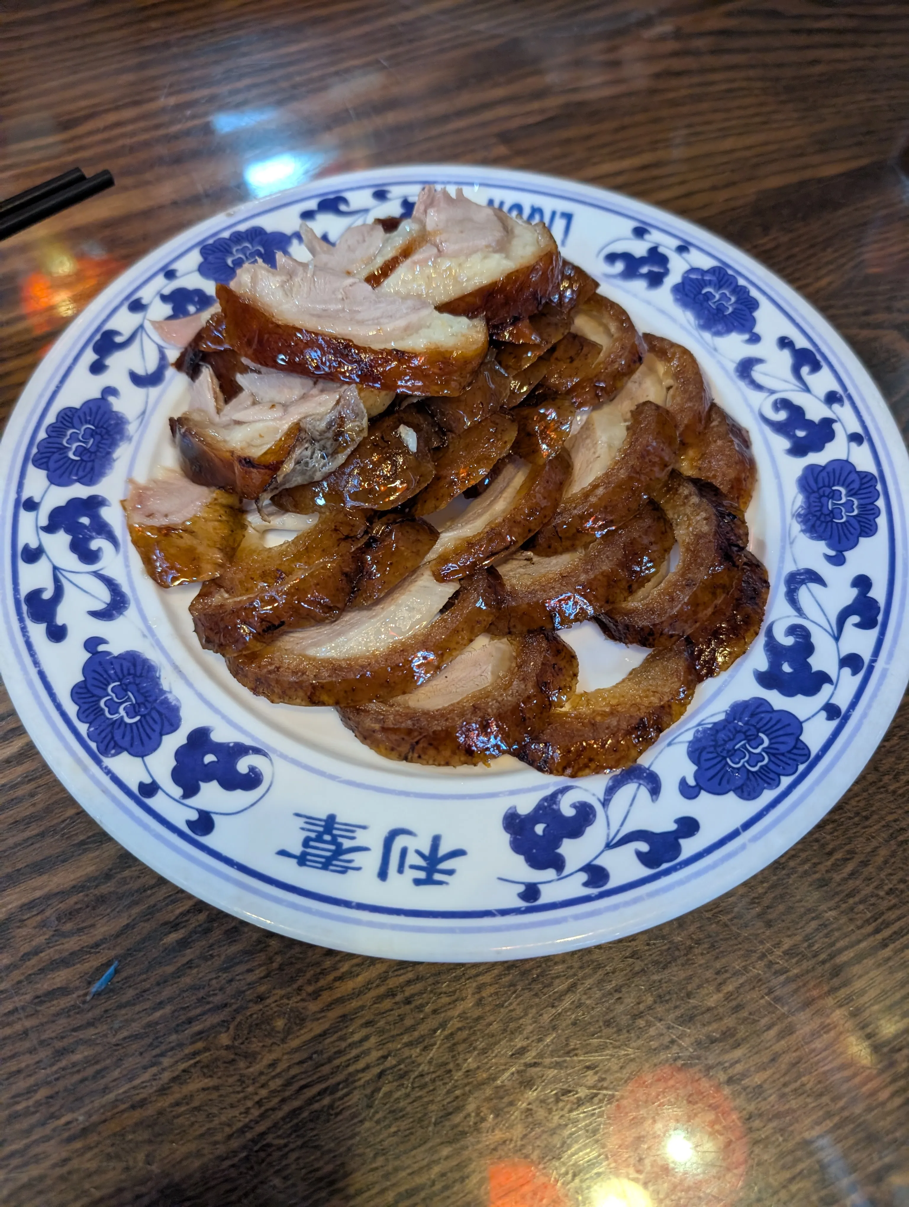 Peking duck in Beijing, served with thin pancakes, scallions, and hoisin.