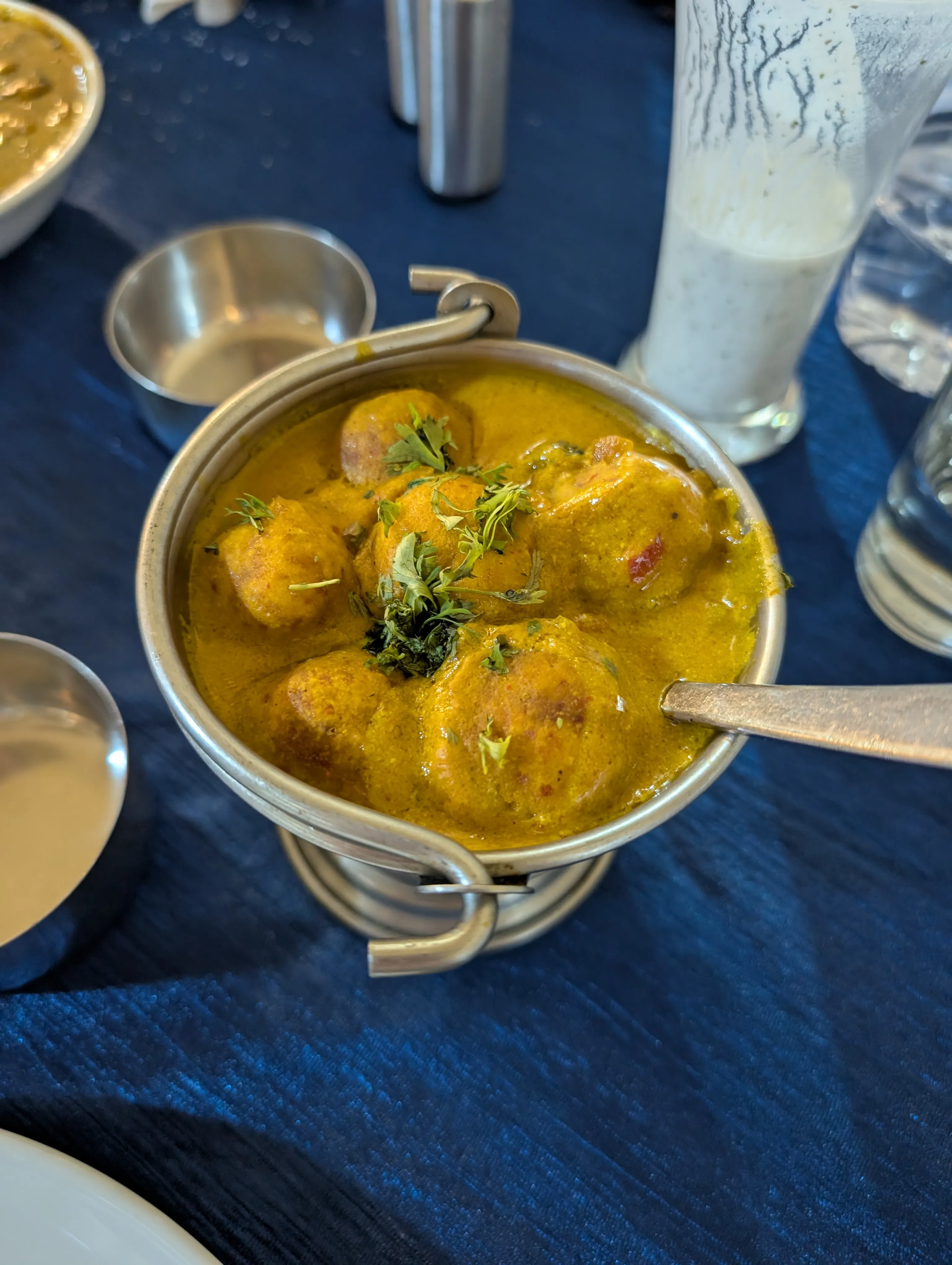 A Rajasthani kofta curry — dumplings bobbing in a golden, turmeric-forward gravy.